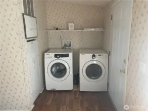 Back door and laundry machines right off the kitchen area.