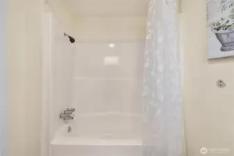 A combination tub and shower offers functionality and convenience, with a clean surround and updated fixtures—ideal for everyday living.