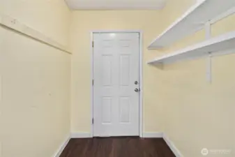 This convenient mudroom entry provides extra storage space with built-in shelving, perfect for keeping outdoor gear, shoes, and everyday essentials organized. Durable flooring makes it a practical drop zone before entering the main living areas.