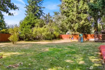 The expansive backyard offers plenty of room to play, garden, or just enjoy the outdoors, with mature trees & fruit trees creating a private and peaceful backdrop.