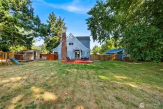 This wide-angle perspective showcases just how much space the backyard provides, perfect for pets, play, or future projects—all within a fully fenced setting.