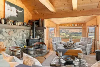 Main level great room hugs you in every corner of this comfortable setting! Warmed by propane fireplace on stone hearth and mantle frame. Large windows and views generously share natural light in this room. Hardwood floors. Vaulted ceilings reflect light of sunrise and sunsets brilliantly.
