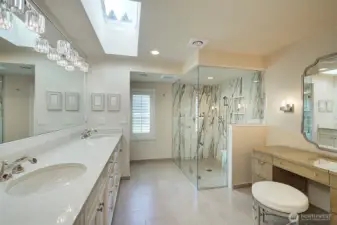 Primary bath with double sinks, walk-in shower, vanity (plumped for tub if so desired) heated floors and skylight.