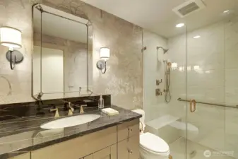 Hall bath that has beautiful designer  touches including walk in shower, sophisticated wall paper and special sink.