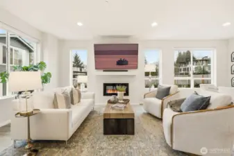 Light-filled living room anchored by a cozy fireplace — perfect for everyday comfort and entertaining.