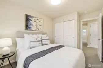 Two additional bedrooms, a full bath, and laundry conveniently located upstairs.