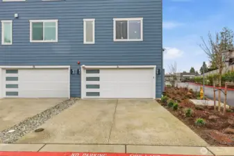 Corner-unit living with driveway parking + a 2-car side-by-side garage (yes, with an EV outlet).