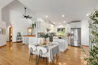 The stylish kitchen features stainless steel appliances, custom tilework, and granite