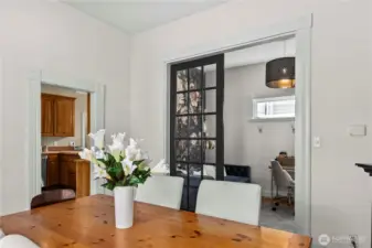 Dining room with bonus room through French doors
