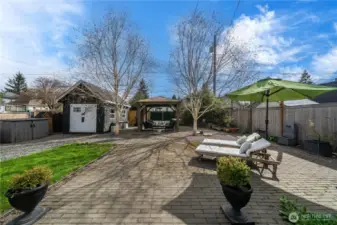 Large backyard with patio and shed