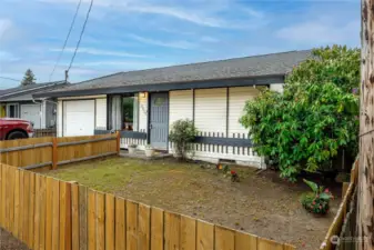 Partially fenced front yard. What will you do with this blank slate? A rose garden, a vegetable garden, install a water feature? Your choice.