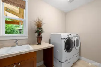 Laundry room with large sink, tile flooring and tile counter top. Washer and Dryer included!