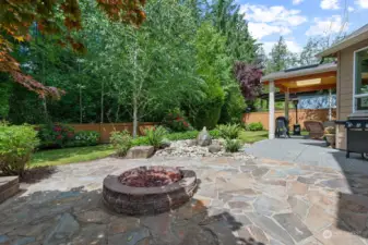 Fire pit and water feature highlight this perfect back yard! Flagstone seating area, gas firepit and beautiful, tranquil water feature.