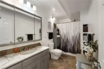 Full bathroom with shower/tub combo and tile floors.