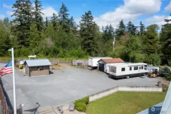 Plenty of parking for all your toys and guests including RV hookups. Detached garage on the right for storage.