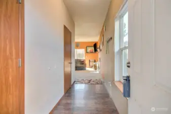 Hallway to living room, garage, laundry, and 1/2 bath on the left