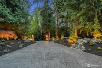 As you enter the property, you are greeted by a custom paved 500' driveway, professional landscape, and a security gate with a keypad & remote access.