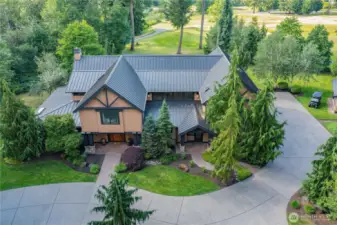 The side entry garage maintains the elegant appeal of the home as you approach. An additional detached golf cart garage is to the right.