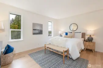 Main floor primary bedroom with ensuite bath and large walk-in closet.