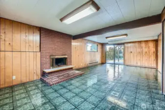 Great room downstairs with classic paneling, brick wood burning fireplace- looking So. toward backyard