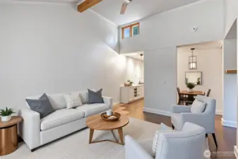 Virtually staged. Living room with vaulted ceiling creates an airy, open feel.