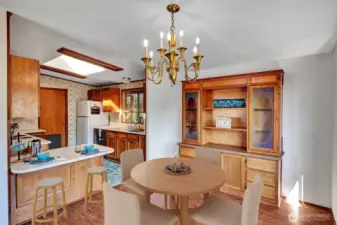 Dining room area with built in hutch and breakfast bar area for your convenience.Virtually staged.