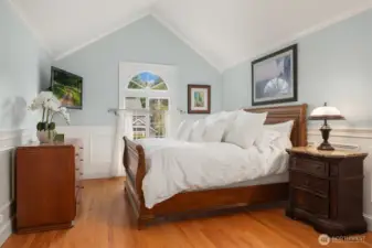 Primary Suite with shiny Swedish flooring, vaulted ceilings, customized closet with jewelry drawer, and built-ins.