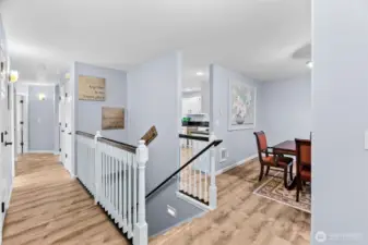 Just inside the front door on the main level, you see a large entry closet and hallway to bathroom & primary bedroom on the left, stairway to the lower level, and dining room & a peek of the kitchen & living room beyond ont the right.