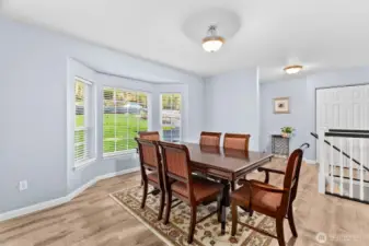 The dining room is spacious with beautiful natural light from the pretty bay windows. Love the luxury vinyl plank flooring found throughout the main floor!