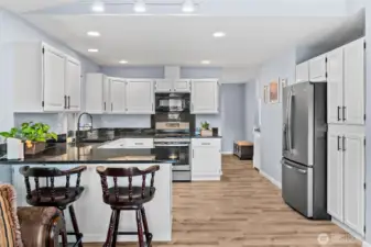 Cozy on up to the eat-in bar at the kitchen counter. Notice the fabulous kitchen storage & great recessed & track lighting!