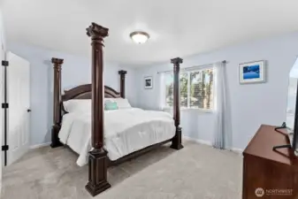 The dreamy primary suite offers new plush carpeting, lake views, a large walk-in closet and fully updated bathroom.