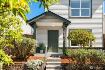 This immaculate home features a covered entry and refreshed landscaping along with new exterior paint.