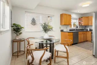 The main living and dining room flow into the kitchen and casual dining area with tiled floors.
