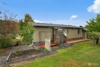 Back side of the home.  Very well kept yard and garden area.