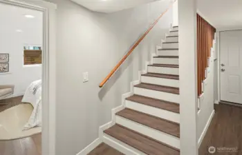 The extra wide stairs lead you to a gorgeous primary bedroom with walk in closet and another full bathroom!