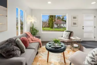 Looking from the kitchen to the living room, notice the gorgeous front door and light filled space.