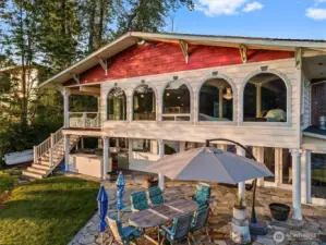 Back of home with outdoor kitchen area and patio