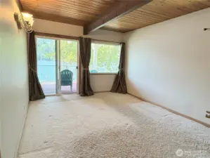 Primary main-floor bedroom with lakeside deck