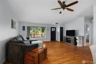 This spacious living room separates the primary bedroom from the other two bedrooms.