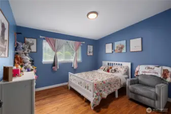 Comfortable and bright bedroom with neutral tones and natural light.