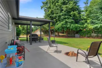 Enjoy the evenings by sitting around this built in firepit on the back patio.