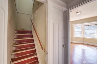 Staircase to the 2nd floor. Just to the right is the door down to the garage.