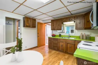 Open door in back of photo connects kitchen to mudroom/laundry room