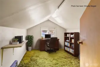 Finished attic space has wall heater, window and door as well as small closet