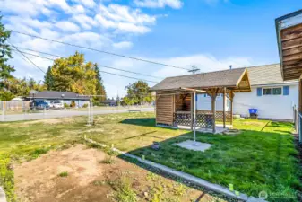 Large yard has clothes line and dorment garden bed areas