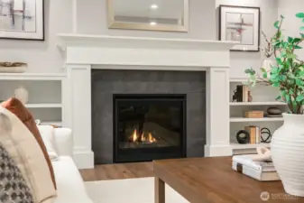 Great Room features gas fireplace with a custom mantle and flanked by built-in shelves.
