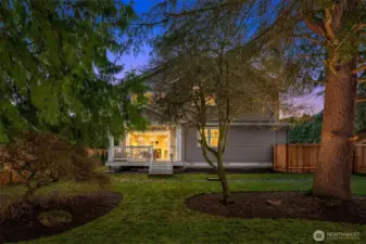 The lighted side yard area offers privacy and mature landscaping.