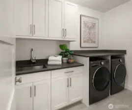 Wondeful Laundry room features LG Washer/Dryer, a large utility sink, abundant cabinets and folding counters.