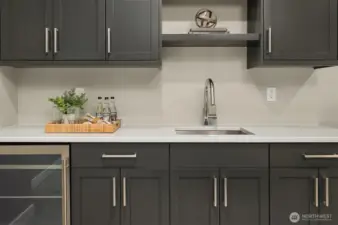 Upper floor Bonus Room/Theatre has an Entertainment bar with sink and beverage fridge.