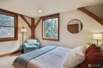 Main floor guestroom features a large closet with built in drawers.